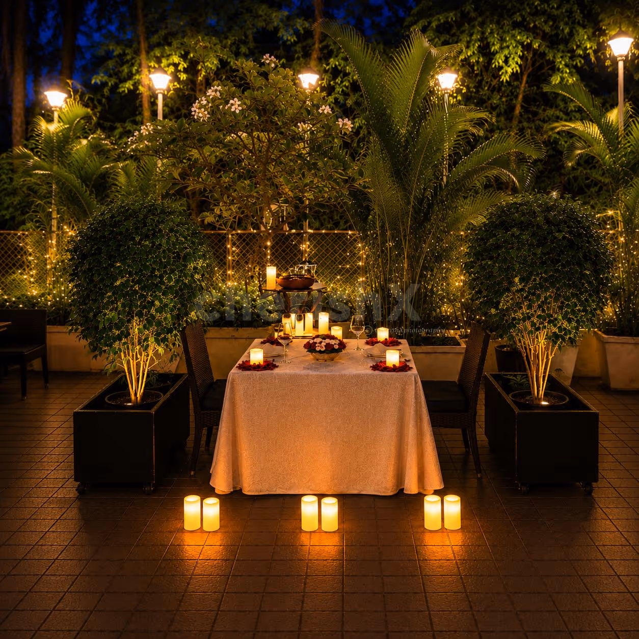 Elegant outdoor dining arranged with candles, floral accents, and ambient lighting for a memorable date night celebration.