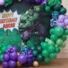 Character cutout of Hulk to attach to balloon arch for superhero birthday theme decoration.
