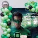 Wall Character Poster And Party Decoration With Black And Green Balloons.