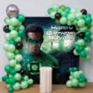 Green Balloon Arch With Superhero Backdrop And Personalised Birthday Banner.