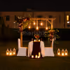 Private outdoor romantic dinner setup with premium décor, glowing candles, and a beautifully styled dining space.