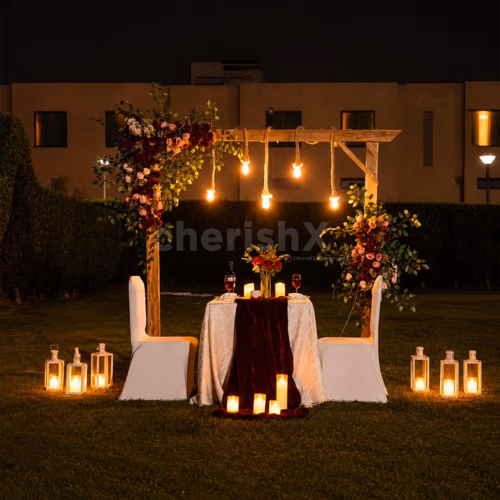 Private outdoor romantic dinner setup with premium décor, glowing candles, and a beautifully styled dining space.