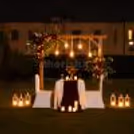 Private outdoor romantic dinner setup with premium décor, glowing candles, and a beautifully styled dining space.
