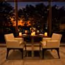 Romantic candlelight dining experience at Four Points by Sheraton featuring elegant table décor, floral arrangements, candles, and a cozy restaurant ambiance.