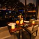 candlelight dinner setup with glowing candles, fresh roses, desserts, and premium dining décor for couples.