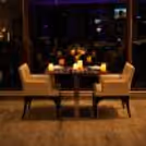 Luxury candlelight dining table with floral centerpiece, warm candle décor, and intimate restaurant ambiance for a romantic evening.