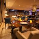 Romantic dining experience at Four Points by Sheraton featuring candlelit table décor, floral arrangements, gourmet dining, and luxury ambiance.