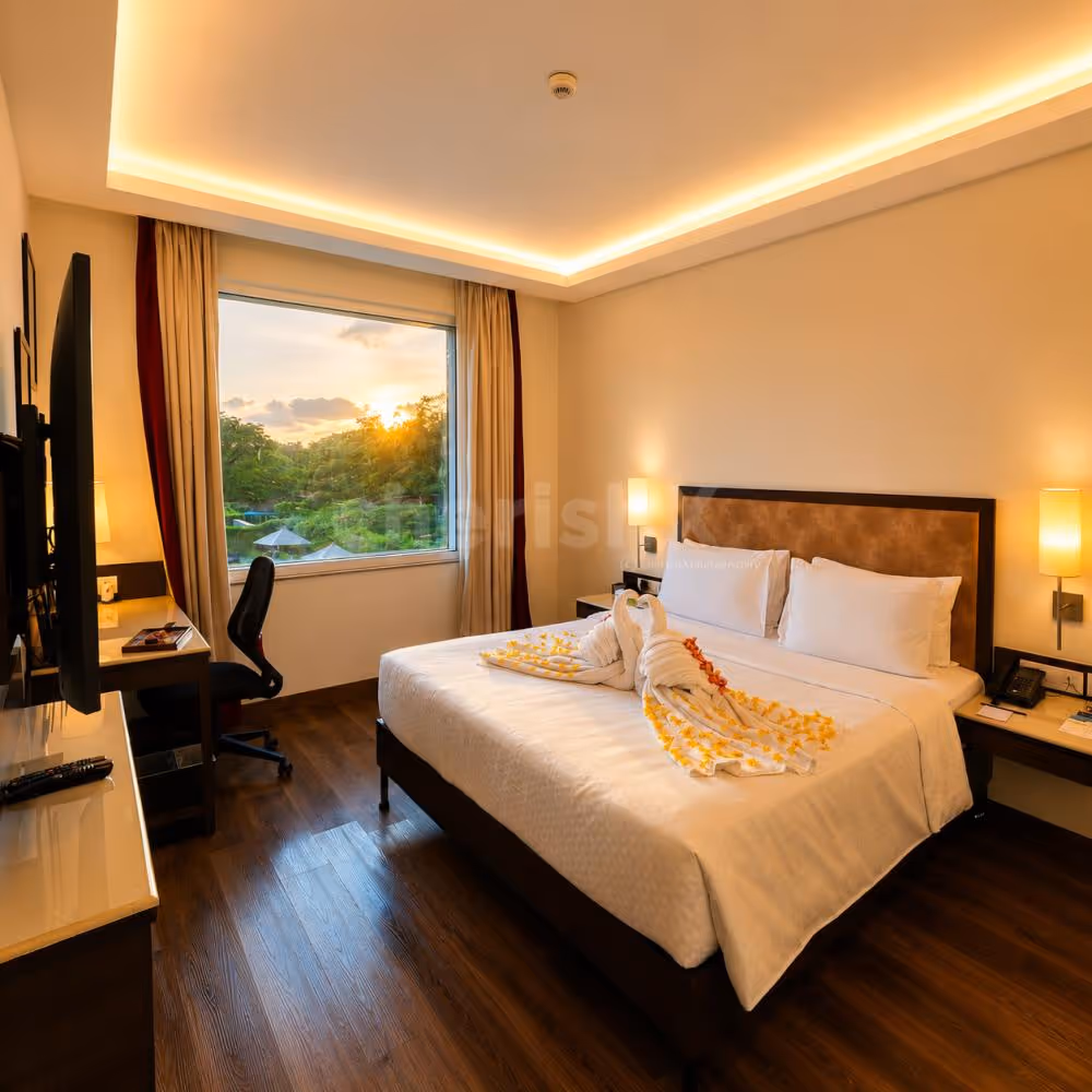 Romantic staycation room with decorative towel art, cozy interiors, and a comfortable king-size bed for a memorable stay.