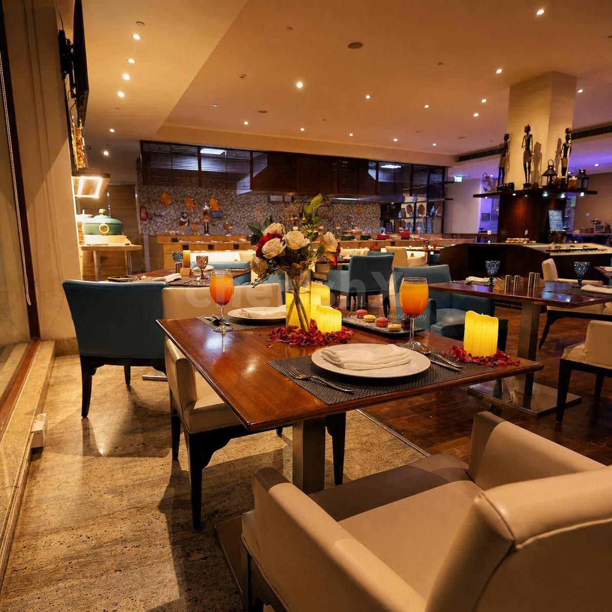 Romantic dining experience at Four Points by Sheraton featuring candlelit table décor, floral arrangements, gourmet dining, and luxury ambiance.