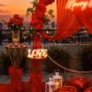 Make your proposal feel straight out of a romantic movie with CherishX. A red-themed rooftop Marry Me setup with flowers, candles, balloon boxes and premium decor details.