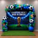Football Background Decoration With A Custom Flex Display, Balloon Arch Around The Setup.