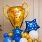 Father’s Day Trophy Balloon Display With Blue Star Foil Balloon And Layered Balloon Bouquet Styling.