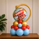 The 'World's Best Dad' Globe Foil Over A Colourful Mix Of Blue, Red And Gold Balloons.