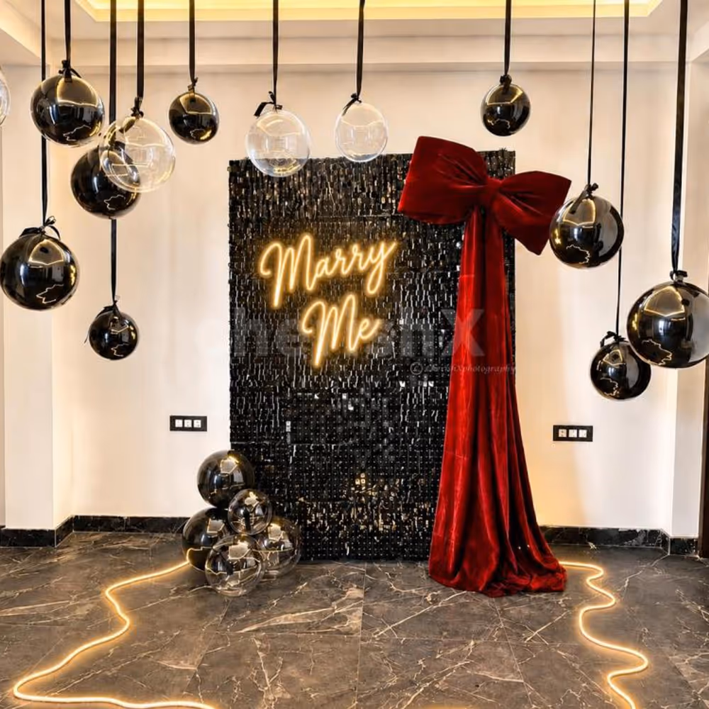 A luxurious Red Bow Marry Me Proposal Decor by CherishX with a sparkling black sequin backdrop, glowing neon sign, and romantic balloon ceiling.