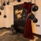 A picture-perfect indoor proposal setup by CherishX with black chrome balloons, clear bubble balloons, red bow detailing, and golden ambient lights.