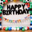 Close-Up Of Football Party Props Including Trophy, Stars And Themed Foil Balloons.