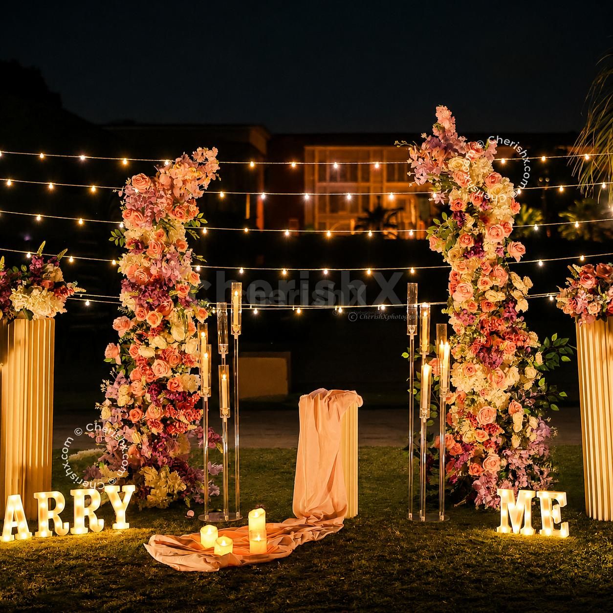 Romantic candlelight dinner under the stars with floral décor and fairy lights.