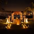 Romantic evening - restaurant with candlelight outside with floral decorations, beautiful table setting, warm light.