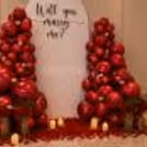 Glass vases with red artificial roses symbolize timeless beauty for close moments.