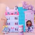 The Kids’ Celebration Setup Features A Themed Cake Table, A Colourful Balloon Arrangement And A Gabby Character Standee.
