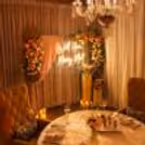 Cabana proposal dinner featuring a table lit by candlelight, floral arrangements, and a neon sign that says Will You Marry Me?