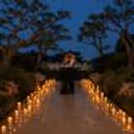 CherishX candlelight proposal decor with a romantic garden walkway, warm candles, flowers, and luxury evening ambience.