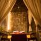 Romantic skyline cabana dining setup with candlelight décor and city views