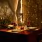 Skyline dining experience featuring a decorated cabana and candlelit ambience