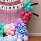 Birthday ring setup for Gabby with a cat character standee of Bluey, pastel balloons and party decorations.