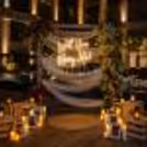 Luxe Proposal By The Pool with a romantic floral design, drapes, candles, and a poolside proposal setting.