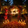 Romantic alfresco proposal dinner setup with candlelight décor, rose petals, and elegant open-air dining for couples.