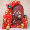 Background Of A Large Superhero With Red And Gold Balloon Arch And Foil Balloons.