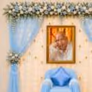 Lighting, Warm, With A Large Guru Ji Portrait With Decorative Hanging Golden Bells.