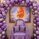 Functional Ceremonial Chair And Matching Decorative Cushions Covered In Purple Fabric And With A Lavender And Silver Balloon Backdrop.