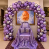 Devotional Seating Area Lined With A Lavender Balloon Arch With Silver Butterfly Accents Above A Spiritual Portrait In A Frame.
