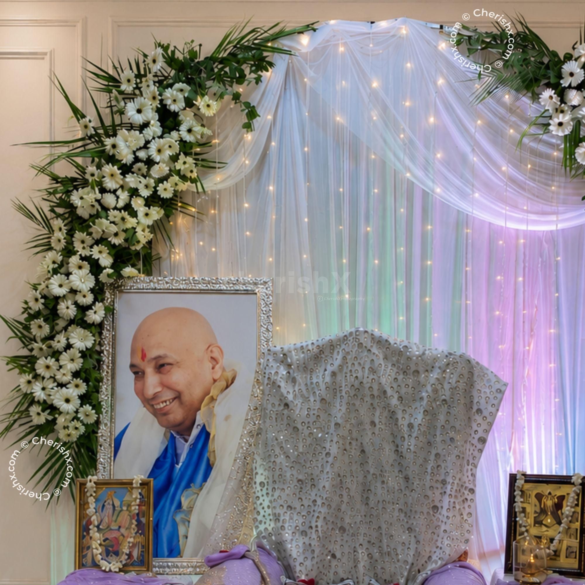 Prayer Arrangement To Include Framed Sacred Images, Rose Petals, Side Tables And Decorative Lanterns Set Beside The Spiritual Seating.