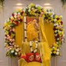 The beautiful floral ring stand is adorned with fresh flowers, greenery, and a Guru Ji image for a devotional birthday celebration.