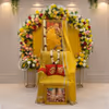 A Round Floral Design Featuring Vibrant Blooms Around A Yellow Cloth Background And An Ornamental Space.