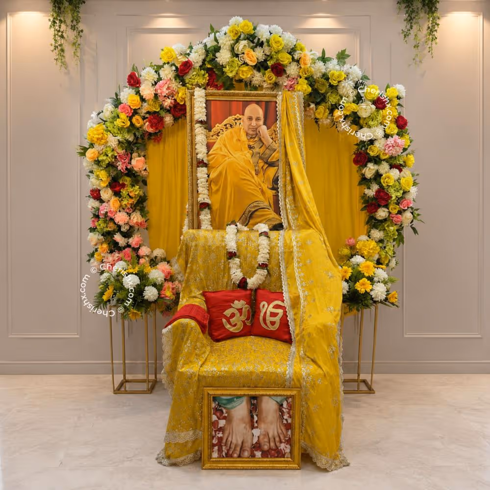 A Round Floral Design Featuring Vibrant Blooms Around A Yellow Cloth Background And An Ornamental Space.