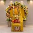To celebrate the birthday of Guru Ji, there is a spiritual portrait with a backdrop of flowers and yellow drapes in a circle.