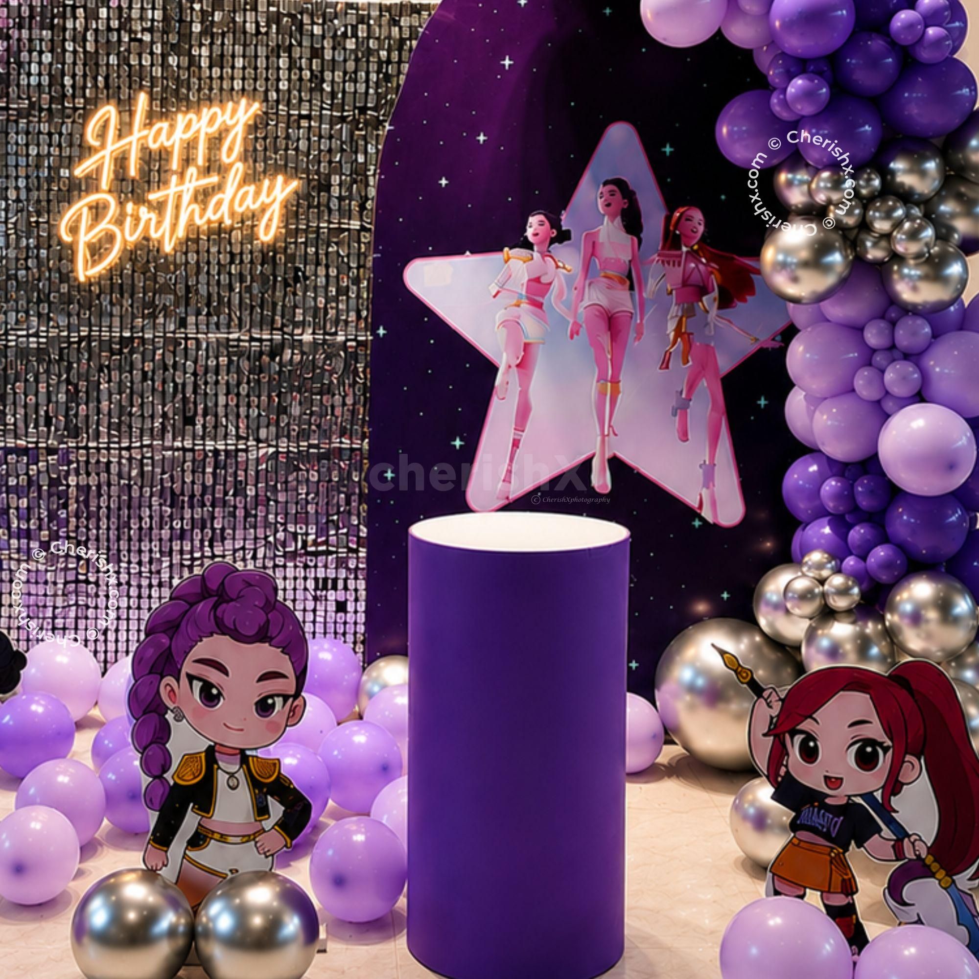 Character Standees Around A Silver Sequin Panel, Decorated With Purple Balloons For A Children's Birthday Party.