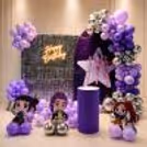 Happy Birthday Neon Light, Purple Balloon Arch, And Sequin Backdrop For A Birthday.