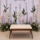 Beautiful Birthday Photo Background With Artificial Flowers And Garden Leaf Patterns.