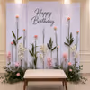 Elegant Sunboard Garden Birthday Backdrop With Pastel Artificial Flowers And Lush Green Leaf Design.