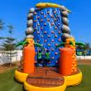 Close-up of textured climbing holds, soft safety surface and colourful adventure-themed elements for active children.