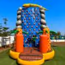 Adventure play area with cushioned steps, palm tree pillars and a safe climbing zone at the front entrance.