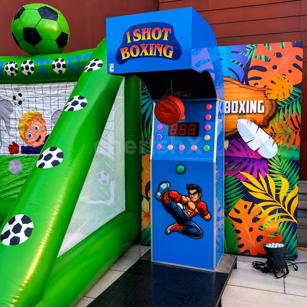 Interactive 1 Shot Boxing Arcade Game with a child testing punch strength at a fun-filled party entertainment setup featuring vibrant event decorations.