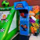 Colourful 1 Shot Boxing arcade machine with a hanging punching bag for a party game.