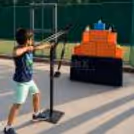 Child taking a turn to hit the colourful Angry Birds targets with the oversized slingshot.