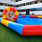 Close-up of an inflatable water roller floating on a brightly colored rectangular pool.